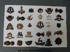 A carded display of 30 British army officer's collar badges, Middlesex Regiment, Hampshire,