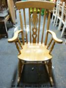 A beech Windsor rocking chair