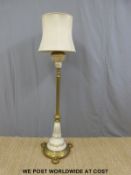 A brass and ceramic standard lamp converted from oil