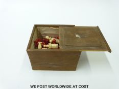 A late 19th/ early 20thC carved bone chess set, one side stained in red,