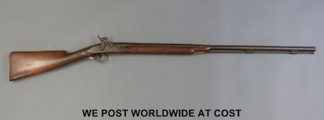 A 19thC percussion converted from flintlock hammer action gun with 34 inch part octagonal barrel,