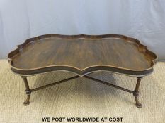 An unusually shaped and galleried metal coffee table with wood effect finish raised on simulated