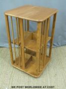 A light elm Ercol style Arts and Crafts revolving bookcase,