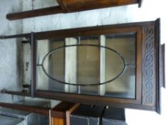 An Edwardian glazed display cabinet raised on tapering legs and spade feet (W52 x D32 x H149cm)