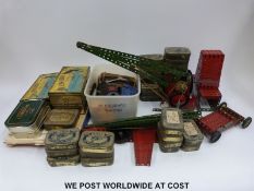 A large collection of Meccano parts including a Gears Outfit, part built crane, booklet, etc.