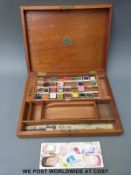 A vintage wooden watercolour box The Students' Box of 'Landseer' watercolours with ceramic mixing