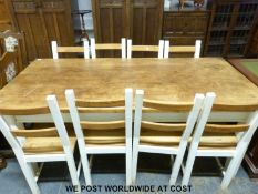 A pine kitchen table with painted legs and eight chairs (L200 x D95 x H79cm)