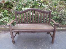 A wooden three seat garden bench
