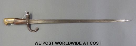 A French 1874 bayonet with wood and brass grips,