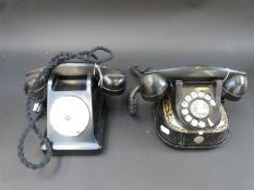 A vintage black bakelite telephone and Bell telephone