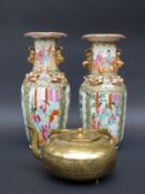 A pair of Chinese Canton famille rose vases decorated with court scenes and gilt dragons and with