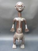 A carved wooden Tabwa figure from the Congo,