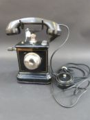 An early/ mid 20thC Danish telephone with crank handle,