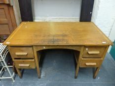 An oak twin pedestal desk (W137 x D76 x H76cm)