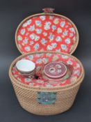 A Chinese tea set in fitted wicker travelling case