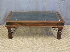 A glass inset hardwood coffee table (L111 x D60 x H40cm)