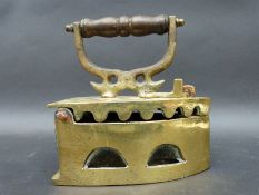 An ornate brass Chinese flat iron 