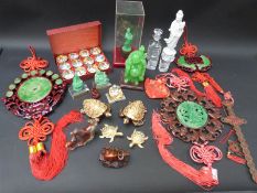 A quantity of Oriental buddha figures, carved horses, jade style plaques,