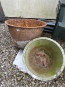 A cast iron pig feed container and a further case iron container