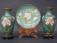 A pair of late 19th/20thC cloisonne vases on wooden bases, 20cm tall, and matching plate on a stand,