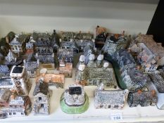 A quantity of Tuskers elephant figures and Tey pottery houses