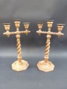 A pair of Scottish turned wooden candelabrum with brass sconces,