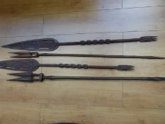 Four carved wooden tribal spears/paddles some with chain link design,