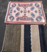 A Turkoman rug with geometric decoration on red ground together with an Indian deep pile rug.