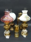 Five brass oil and other lamps,