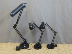 Three various angle poise lamps