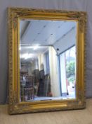 A large gilt framed bevelled edge mirror,