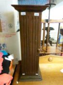 A stained pine cupboard in the form of a column/jardiniere stand,