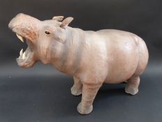 A leather hippo footstool,