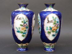 A pair of Japanese Ginbari enamel vases with bird and flower decoration on blue ground (18.