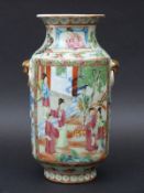 A 19thC Chinese famille rose vase decorated with court scenes and blue Dogs of Fo with gilt