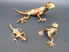 Two decorative ceramic lizards and a similar frog