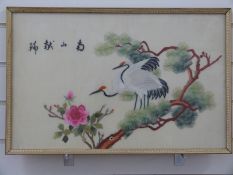 A Chinese embroidery on silk of birds on a branch with script top left,