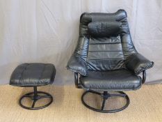 A modern leather reclining easy chair and footstool