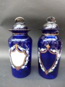 A pair of blue glass apothecary jars,