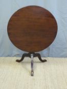 A 19thC circular tilt top table raised on tripod base (D81 x H66cm)