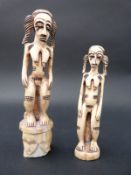 A pair of African carved ivory figures,