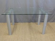 A modern glass topped table and three chairs (L138 x W78 x H75cm)