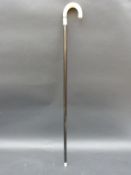 An ebony and ivory walking stick,