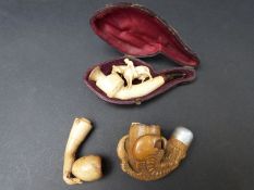 A cased Meerschaum pipe and two other examples
