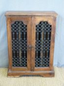An Eastern hardwood two door cabinet with metal grille fronts (W63 x D21 x H87cm)
