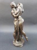 A bronzed figure group of two naked lovers kissing, 36cm tall.
