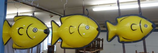 Three very large graduated illuminated fish,