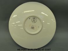 A retro Poole charger bowl with dolphin decoration,