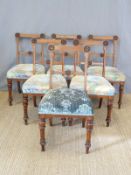 Six oak framed dining chairs with upholstered seats and carved decoration to backs raised on turned