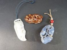 Three Chinese carved hardstone pendants